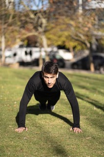Man doing push ups in the park
