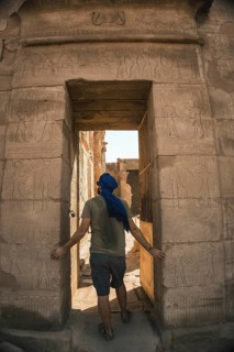 Portrait of a young man with a blue turban at the entrance to the Edfu Temple near the city of Aswan. Egypt