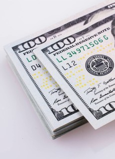 American 100 dollar banknotes made of paper placed on white background