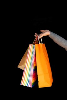 Shopping bags in the woman hands. Joy of consumption. Purchases