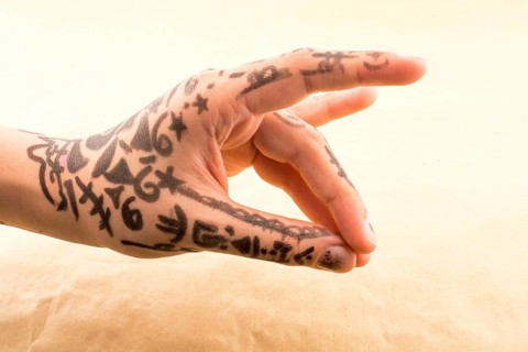Hand with tattoo on a background