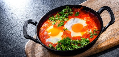 Shakshouka dish in a cast iron pan