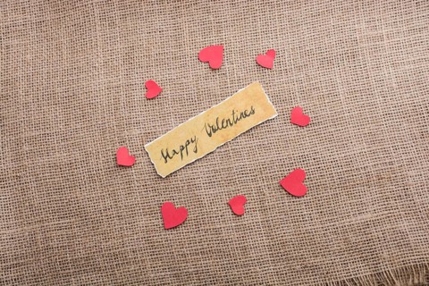 Love icon and Valentine's day wording on torn paper