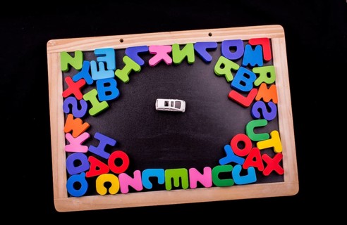 Car and Colorful Letters of Alphabet made of wood