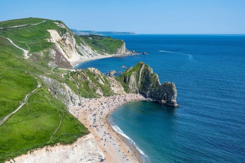 View over the chalk coast with the famous rock bridge Durdledoor
