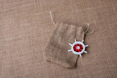Steering wheel of a boat on a sack on canvas