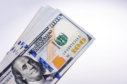 American 100 dollar banknotes made of paper placed on white background