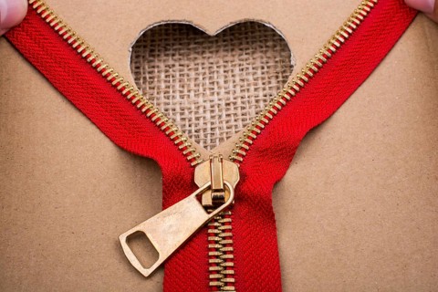 Zipper and heart shape hole on paper