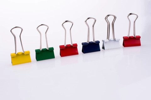Colored paper clips on a white background