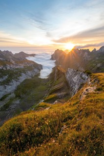 View over Saentis mountains into the valley of Meglisalp at sunrise