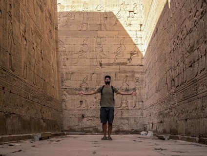 A young tourist visiting the beautiful temple of Edfu in the city of Edfu