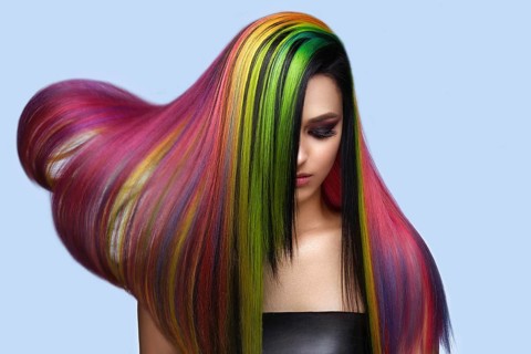 Portrait of beautiful woman with multi-colored hair and creative make up and hairstyle