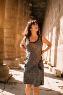 Portrait of a young brunette on the columns of the Edfu Temple near the city of Aswan. Egypt