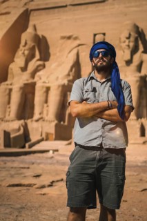 A young tourist with a blue turban visiting the Abu Simbel Temple in southern Egypt in Nubia next to Lake Nasser. Temple of Pharaoh Ramses II