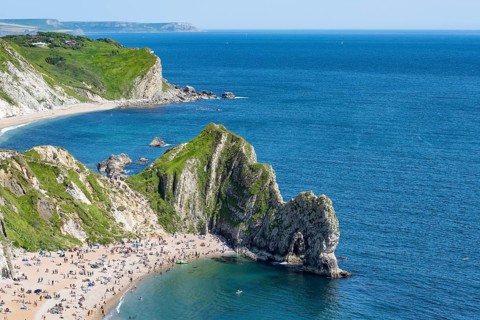 View over the chalk coast with the famous rock bridge Durdledoor