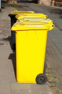 Yellow bins for plastic waste standing on the street