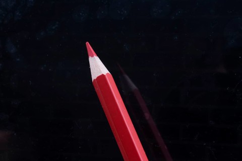 Red Pencil on a black background
