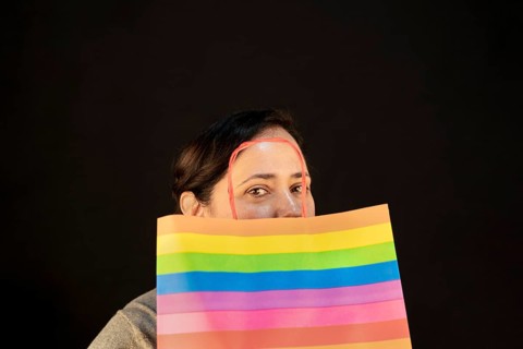 Woman holding lgbt bag. Joy of consumption. Purchases