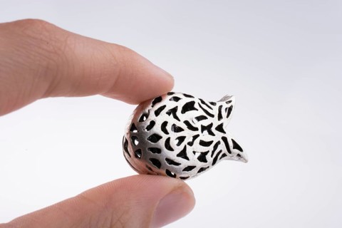 Hand holding a tulip model on a white background