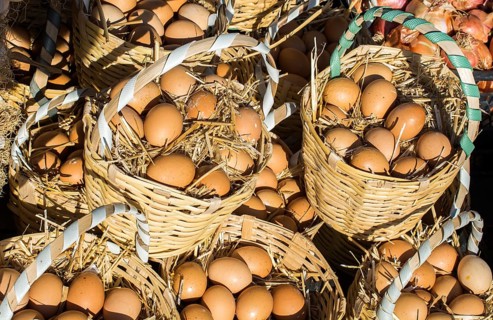 Organic fresh farm eggs in the straw basket