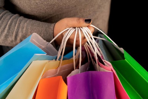 Shopping bags in the woman hands. Joy of consumption. Purchases