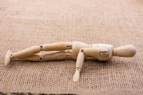 Wooden dolls of a man posing on canvas