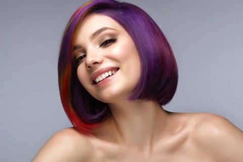Portrait of beautiful woman with multi-colored hair and creative make up and hairstyle