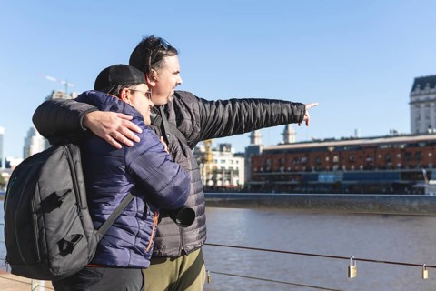 Tourist gay couple exploring Puerto Madero