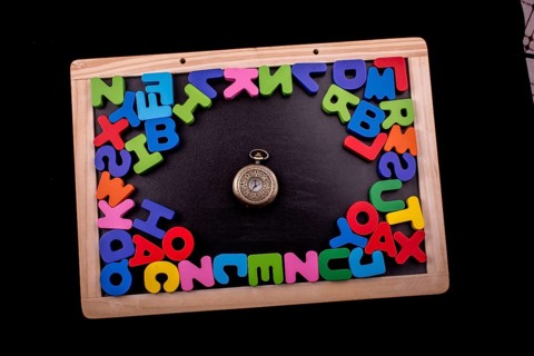 Pocket watch and colorful Letters of Alphabet made of wood