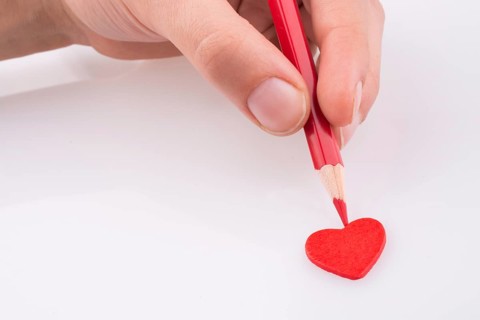 Pencil pointing a red heart