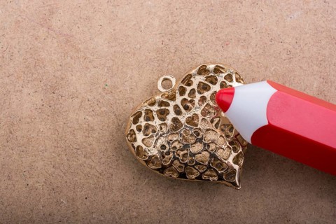 Model pencil on a heart shaped object