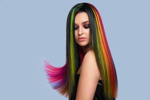 Portrait of beautiful woman with multi-colored hair and creative make up and hairstyle