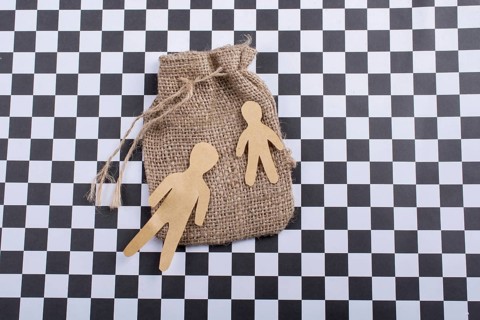 Man shape cut out of paper on canvas sack