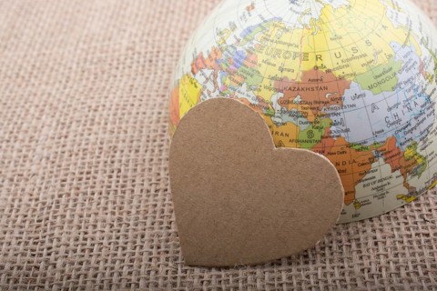 Heart shaped object by a model globe on canvas
