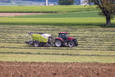 Farmer with tractor in a field in spring