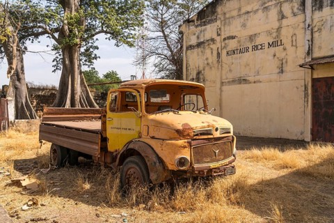 Wrecked truck in front of the abandoned former rice mill in Kuntaur