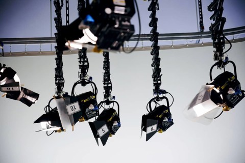 Spotlights hang from the ceiling in a television studio. Berlin