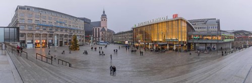 Church of St. Mary's Assumption and main railway station with station forecourt