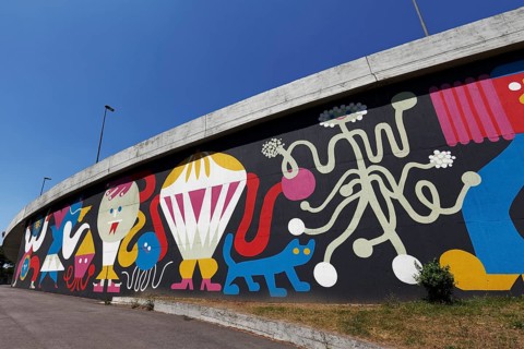 Colourful mural with fantasy figures by graffiti artist Mariana Malhao
