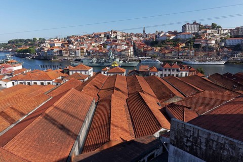 View over the roofs of port wine cellars in Vila Nova de Gaia to the historic old town of Porto