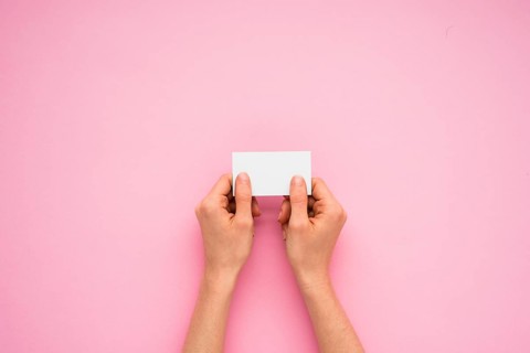 Person hands holding little paper