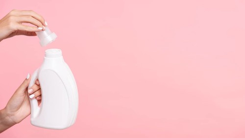 Close up woman opening detergent bottle