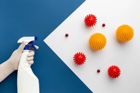 Flat lay hand holding disinfectant against viruses