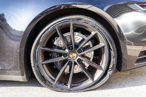 Burst tyre on a Porsche sports car