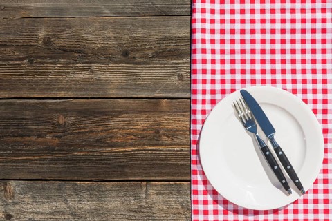 White plate checkered table cloth wooden textured plank
