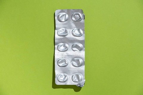 Empty tablet blister pack against a monochrome background
