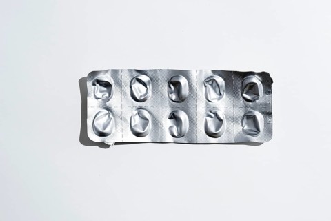 Empty tablet blister pack against white background