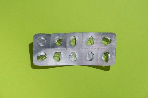 Empty tablet blister pack against a monochrome background