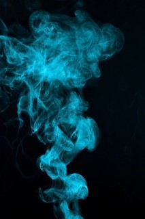Beautiful blue smoke pattern spread black backdrop