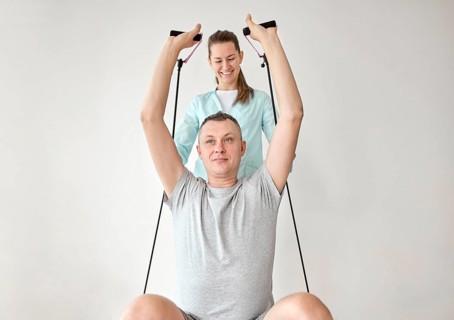 Therapist undergoing physical therapy male patient